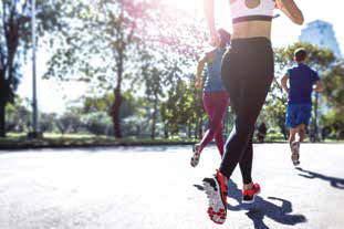 Fit people exercising and running in the city streets and public park